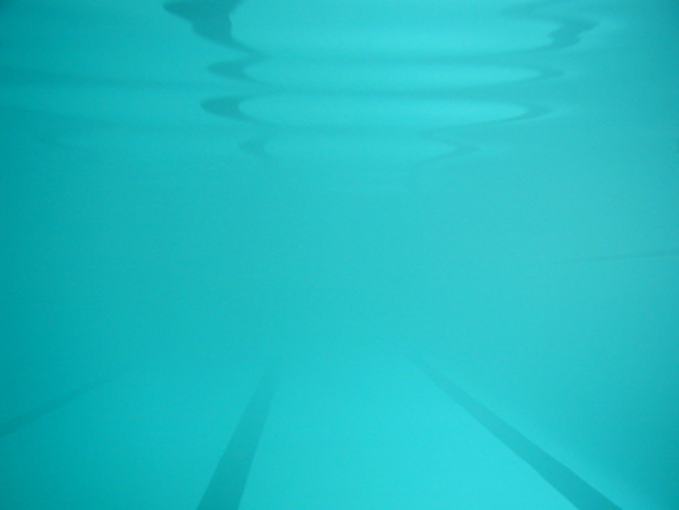 Underwater photo of an indoor pool with poor water clarity