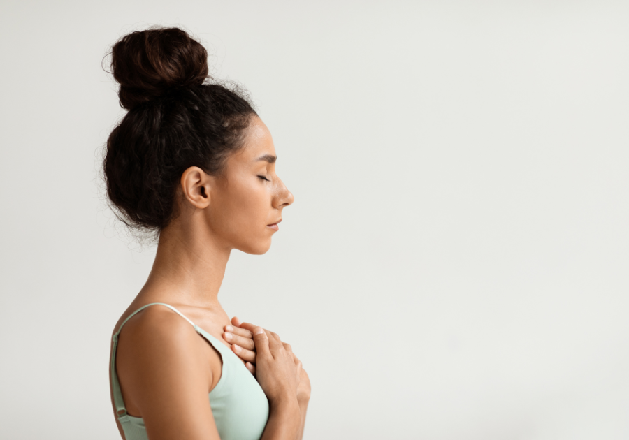 Woman calming her nervous system with breath and stillness, supporting vagus nerve regulation.