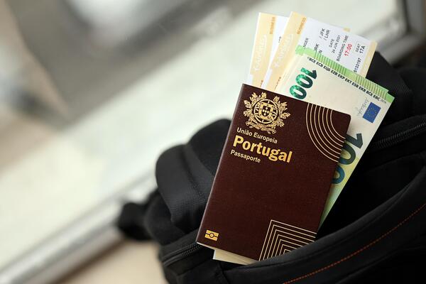 Portuguese passport, euro, and plane tickets