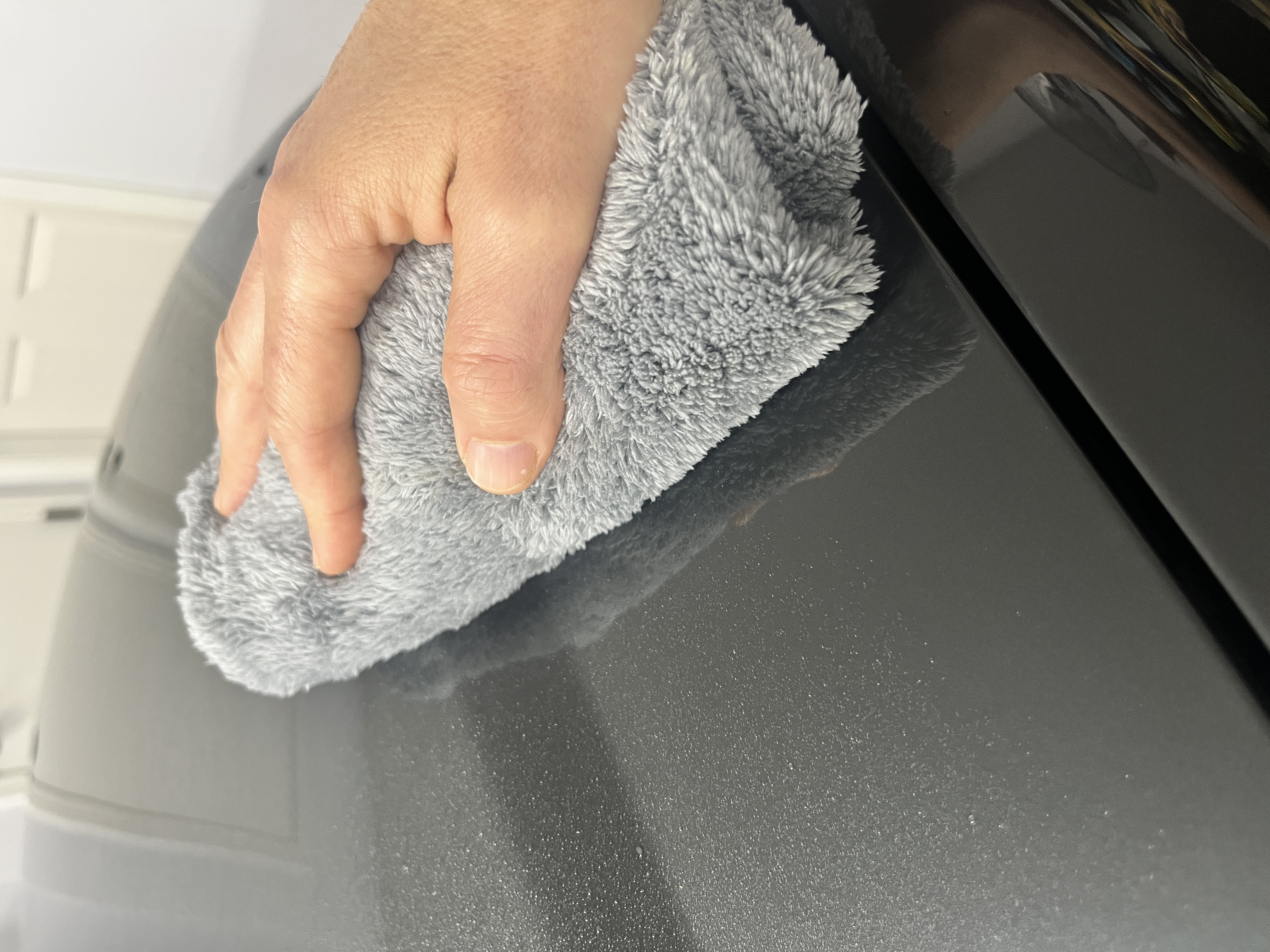 Microfiber towel folded on car paint