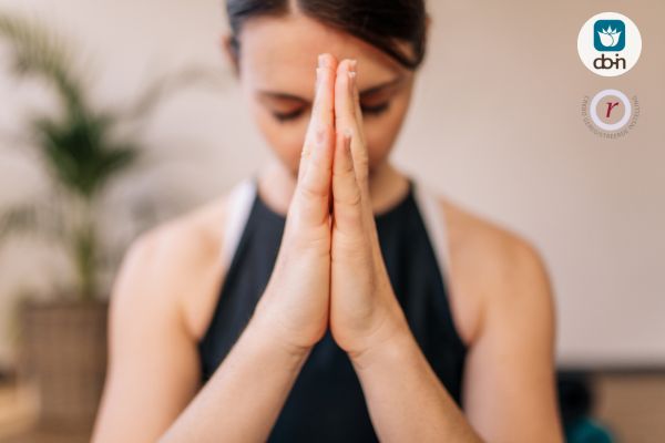 Vrouw in meditatieve houding om overprikkeling te balanceren met Do-In Yoga