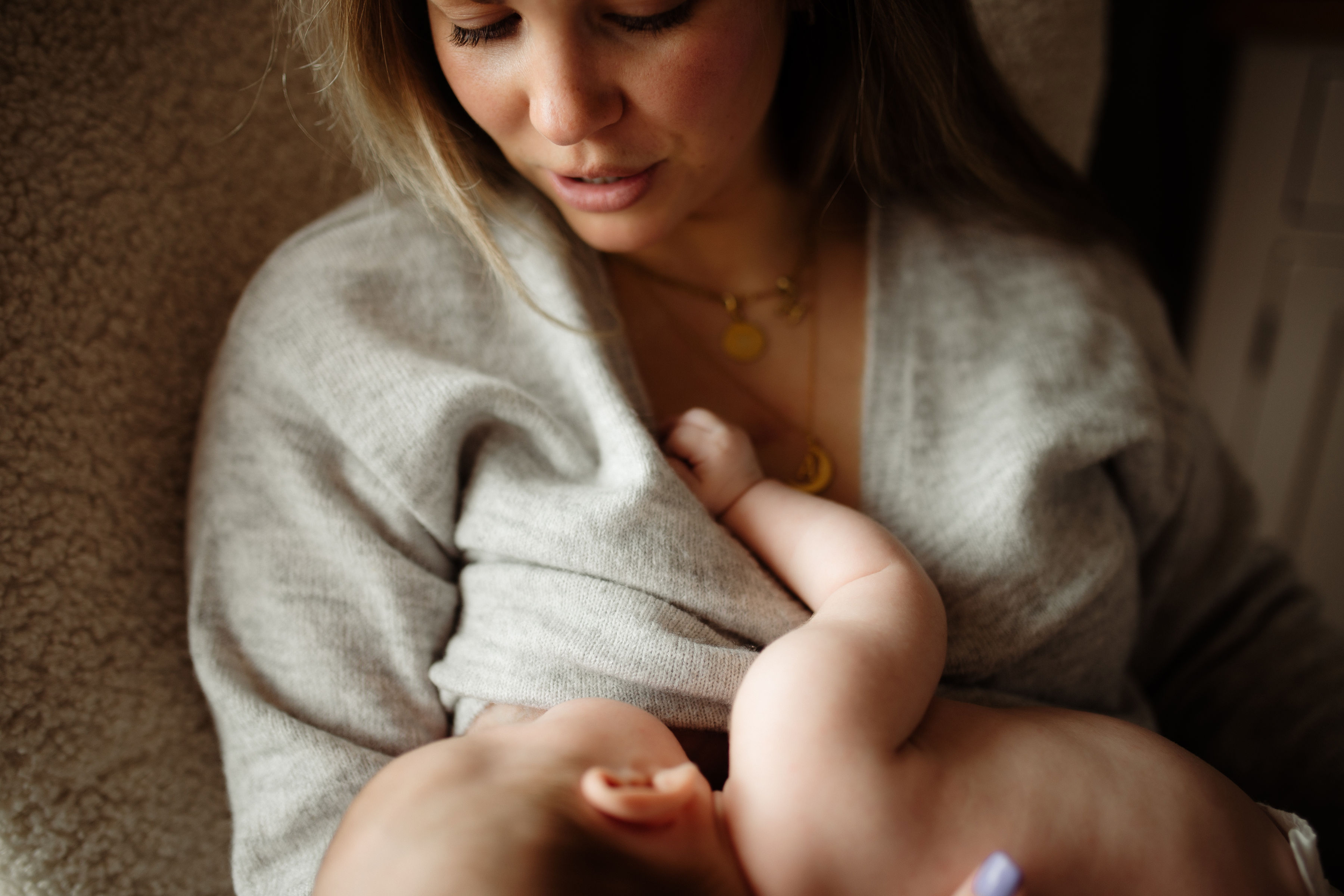 A close up of a Mum breastfeeding her young baby.