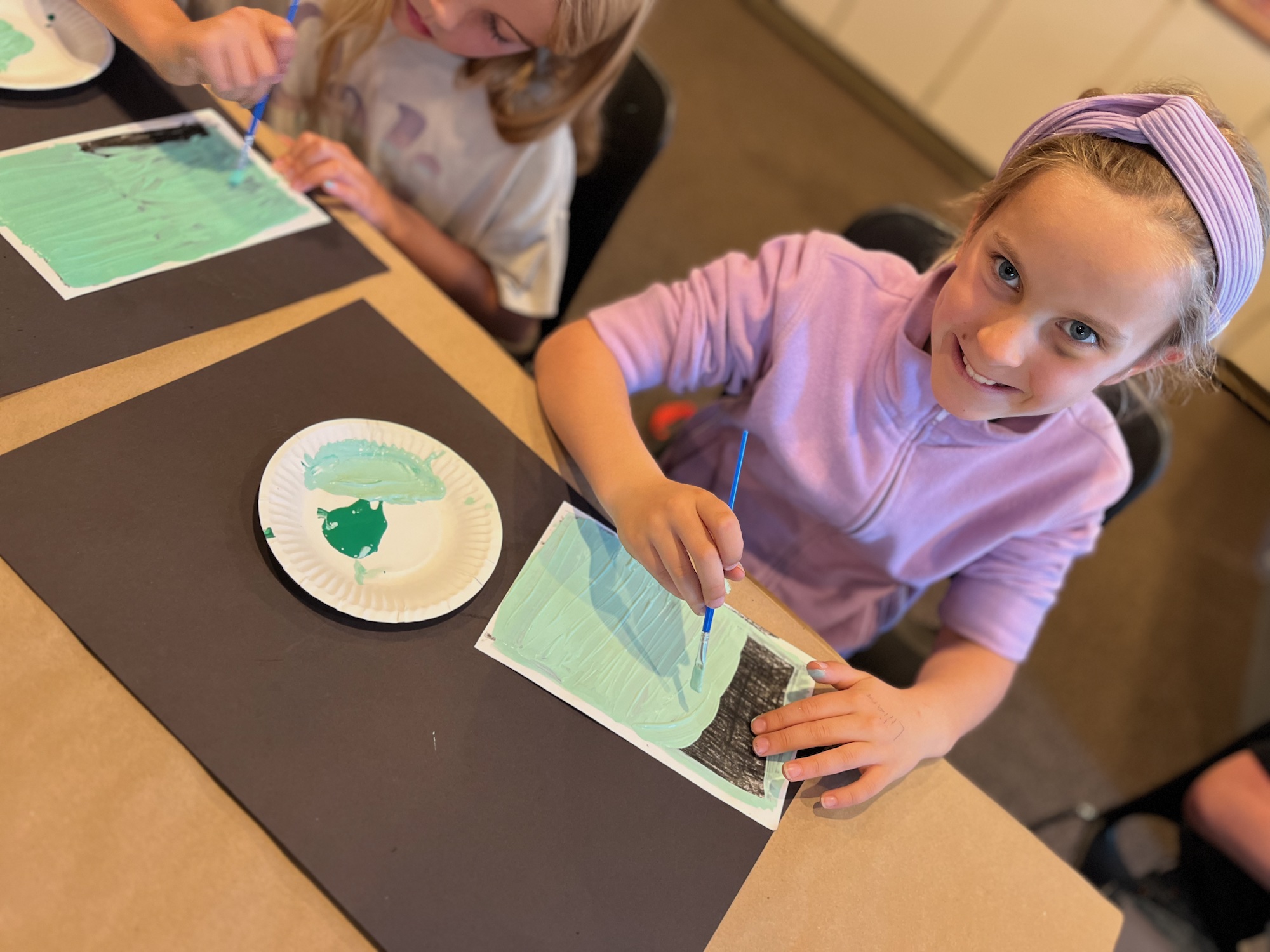 Painting celadon over black crayon as a step for designing a prunus vase - a creative idea for teaching A SINGLE SHARD by Linda Sue Park, from LitWits Workshops