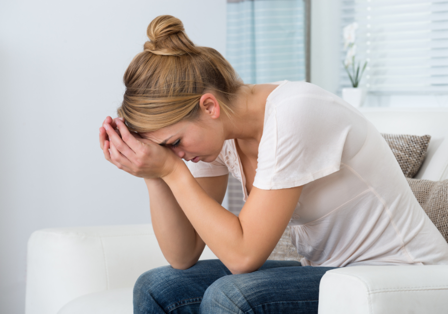 A woman sitting in a chair feeling overwhelmed