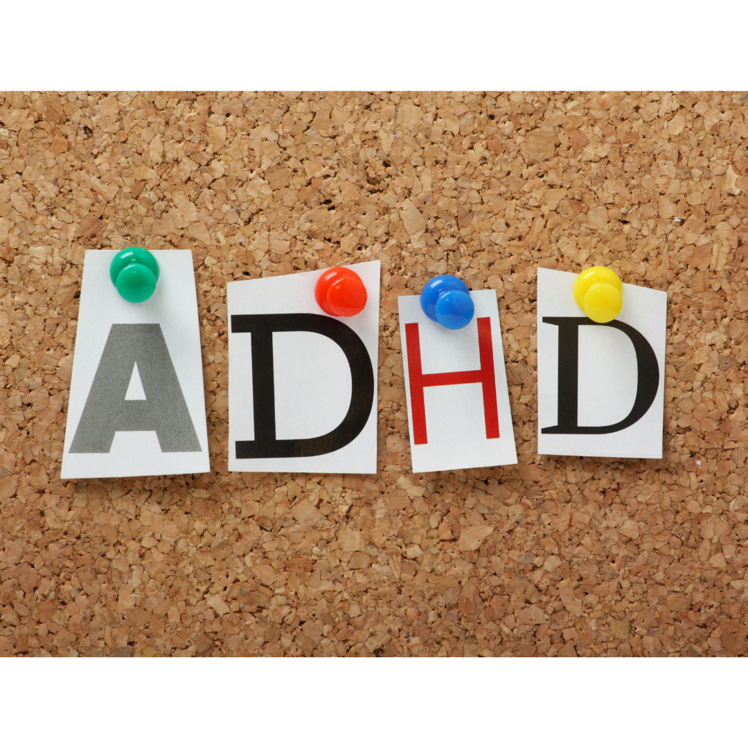 cut out letters "ADHD" pinned to a corkboard