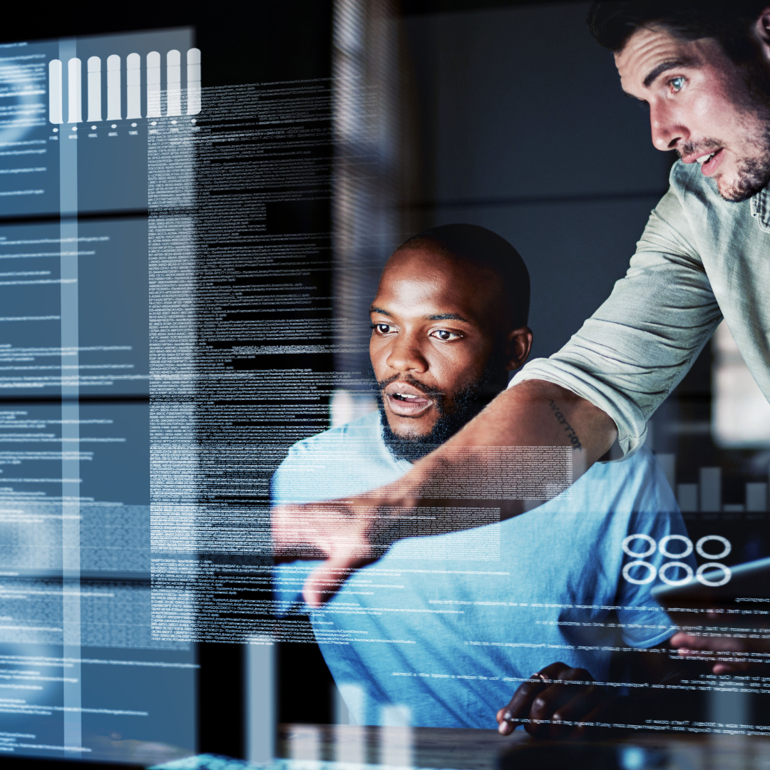 2 men looking at high tech data