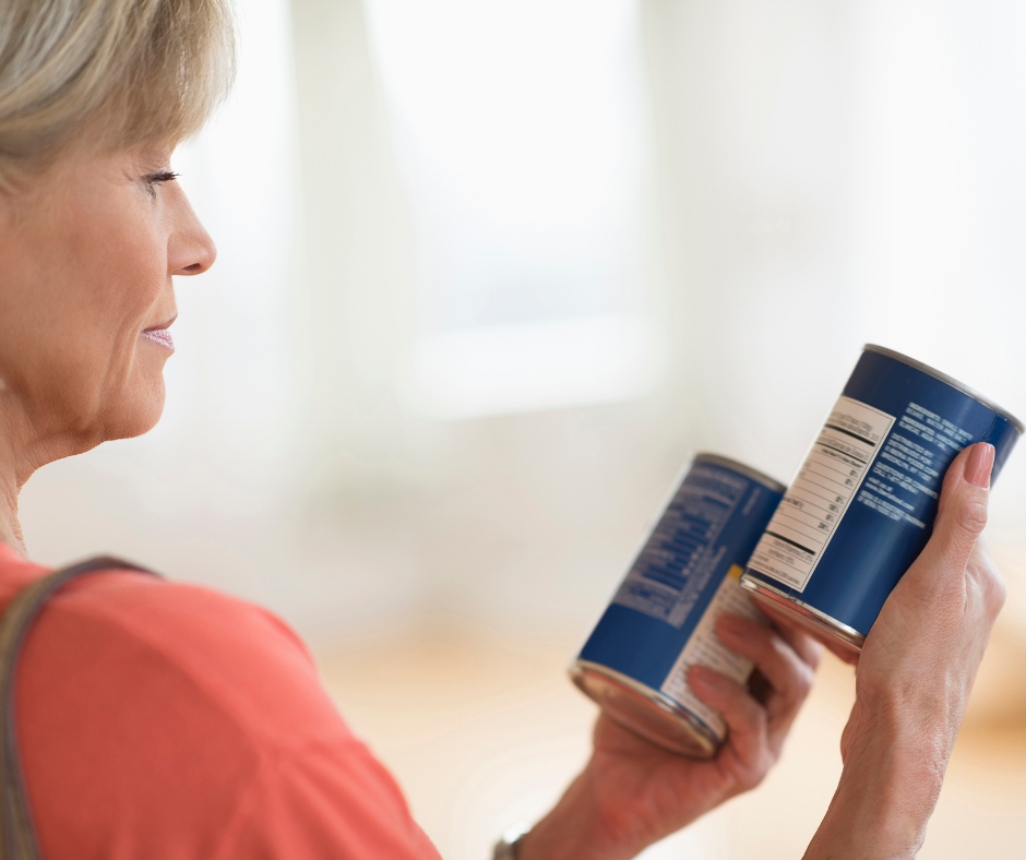 Woman checking soup labels for sodium