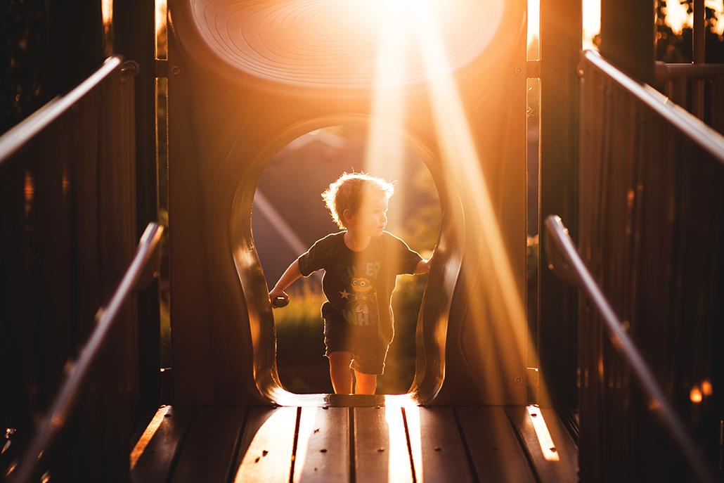 child on playground with leading lines leading to him