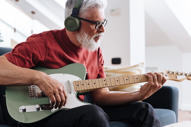 older man learning lead guitar