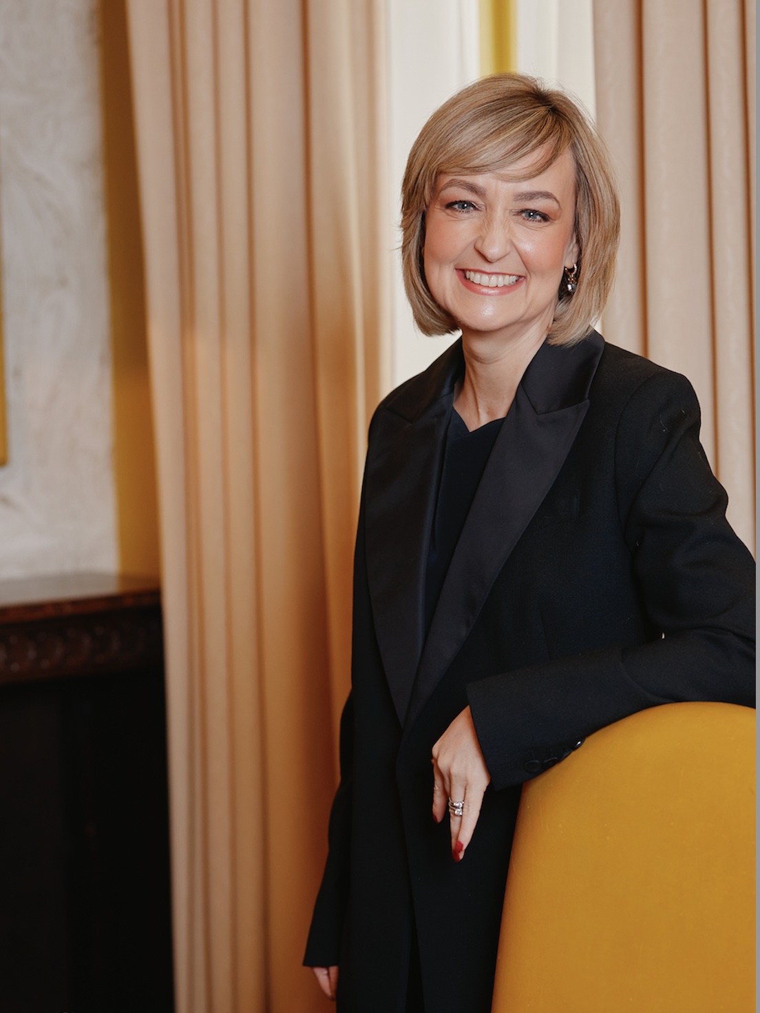 Fiona McKay, The Menopause Career Coach, Menopause Influencer and expert menopause at work strategist stood in her boardroom