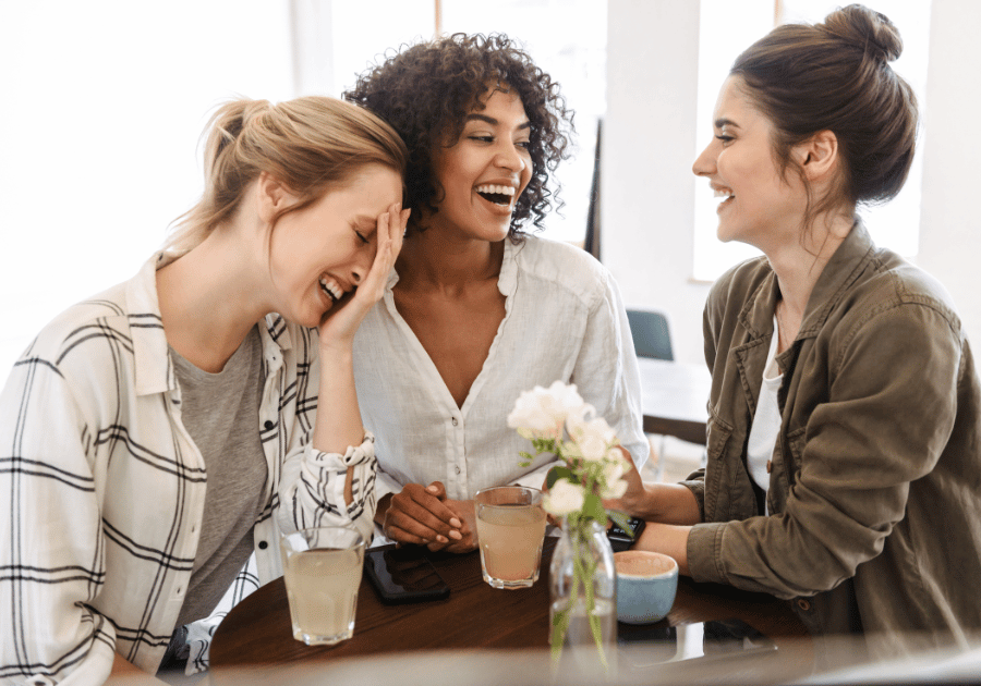 Group of diverse women laughing, representing community and authentic wellness