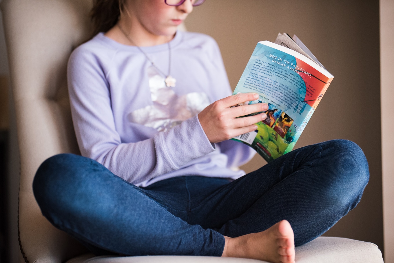 child reading wings of fire during lifestyle photography session