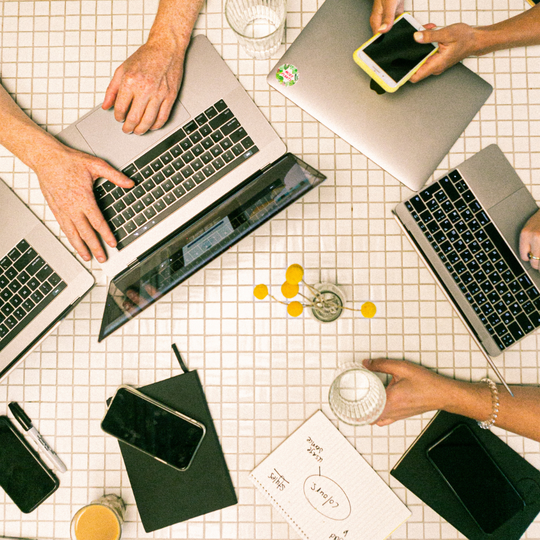 a bunch of people with laptops and phones for workones on a t