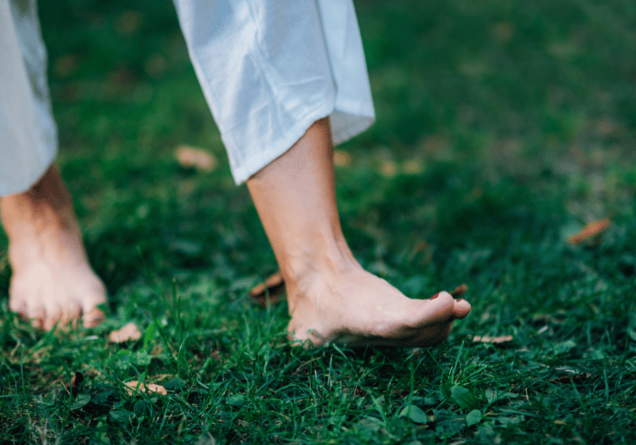 Feet walking through grass 