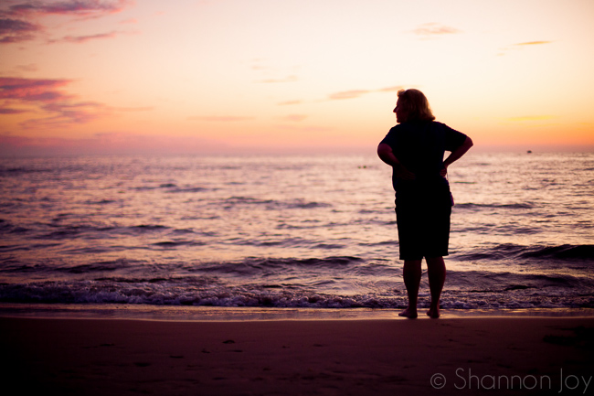 woman on a beach in sunset silhouette photography