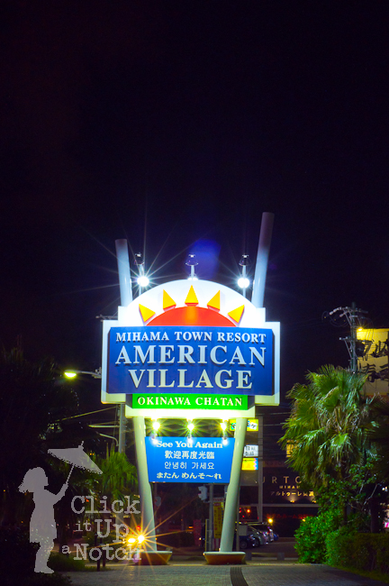 A lit up sign at night showing multiple starburst effects. 