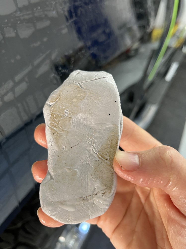 Clay bar removes iron particles from black car paint