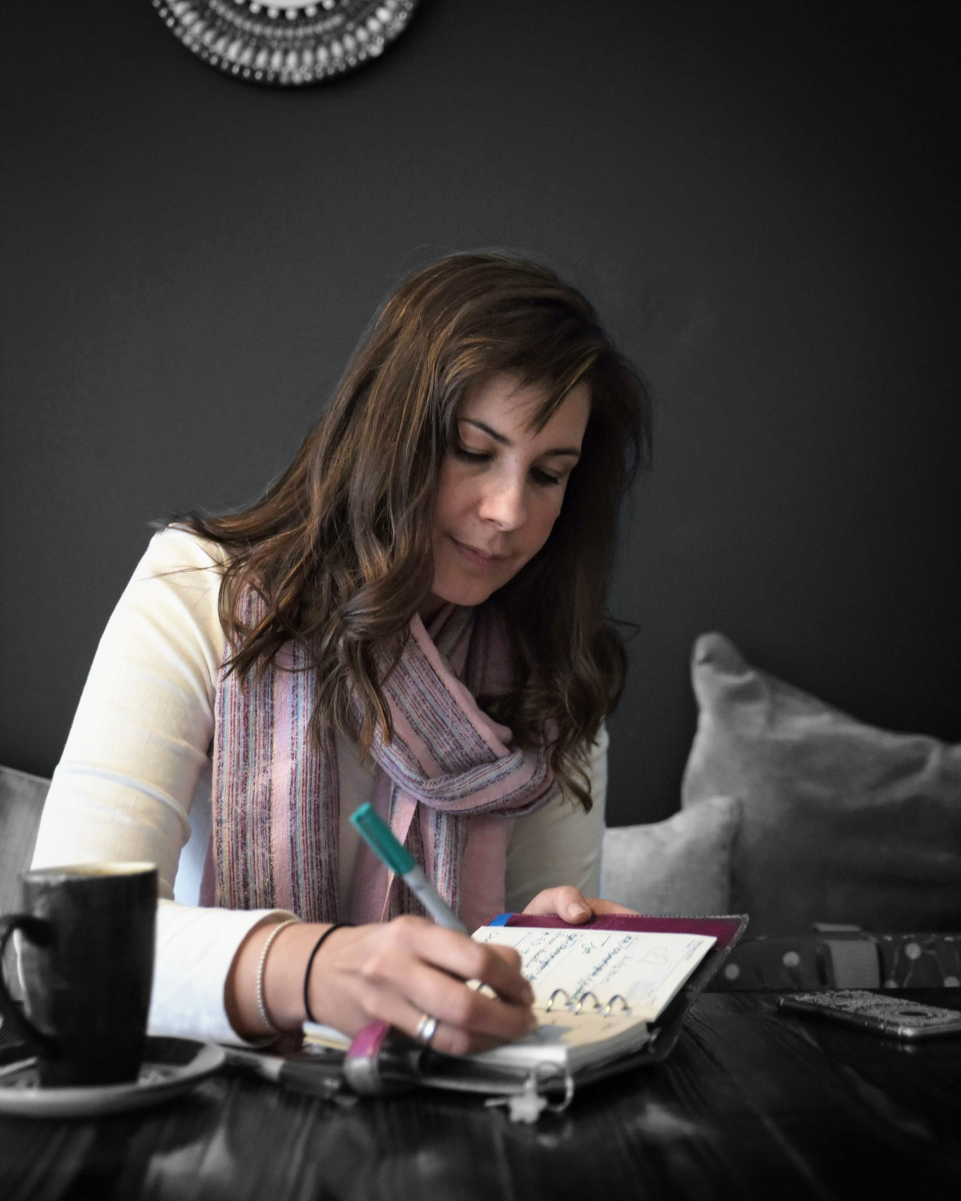 Claire in coffee shop writing/ blogging