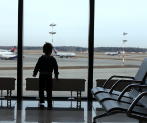 A Filipino child staring at the airplanes at the airport