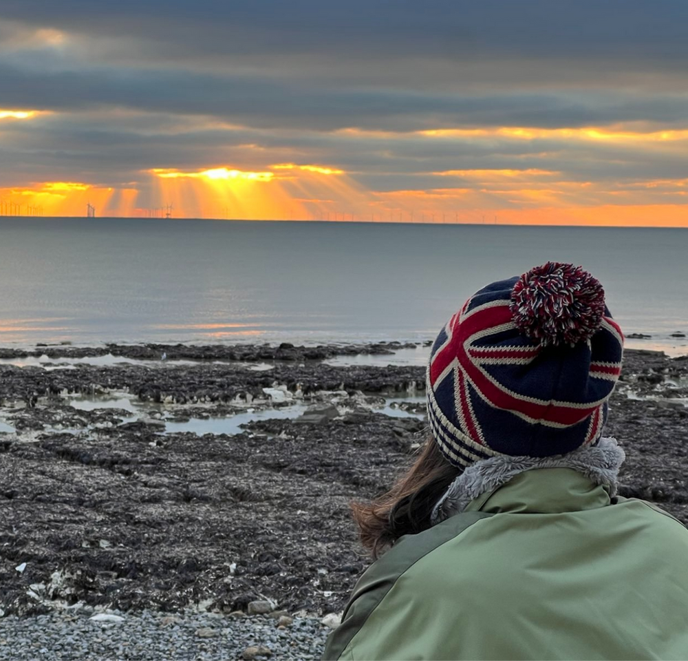 White feather gently floating down towards and open hand