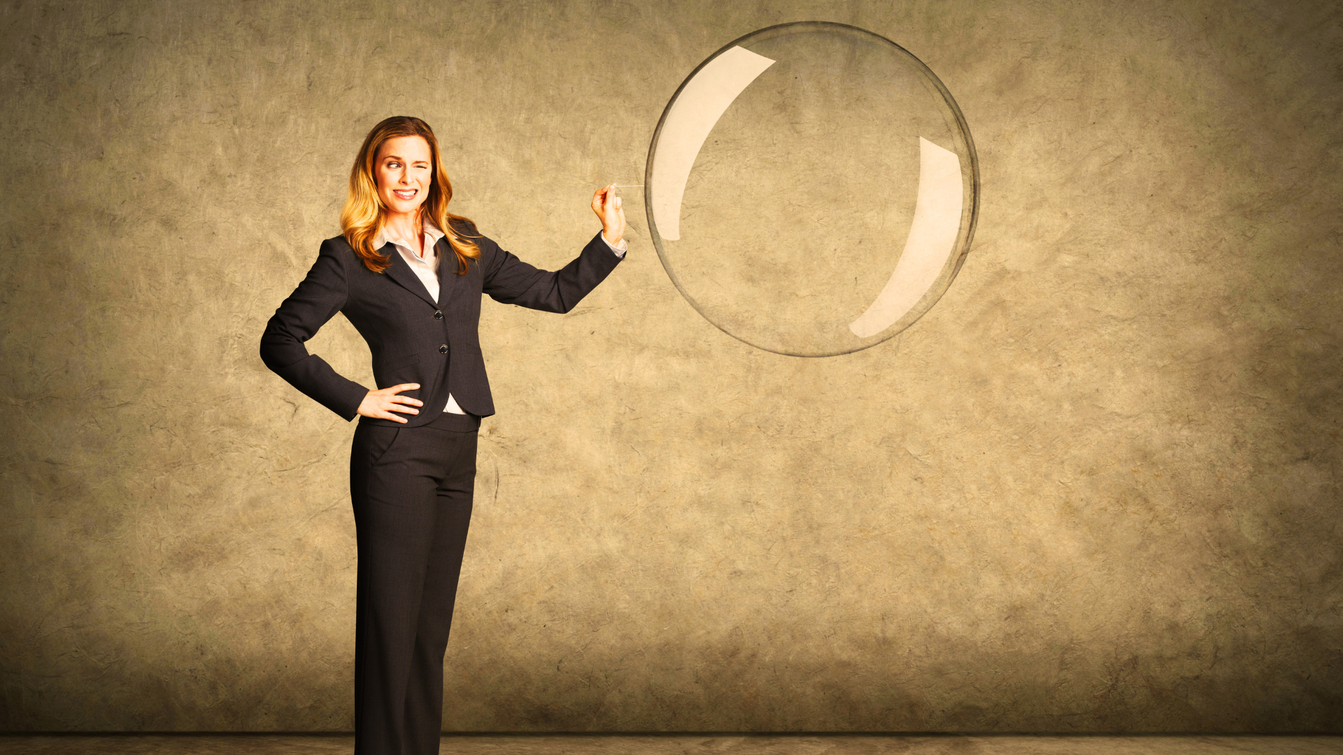 woman in a suit about to pop a large bubble