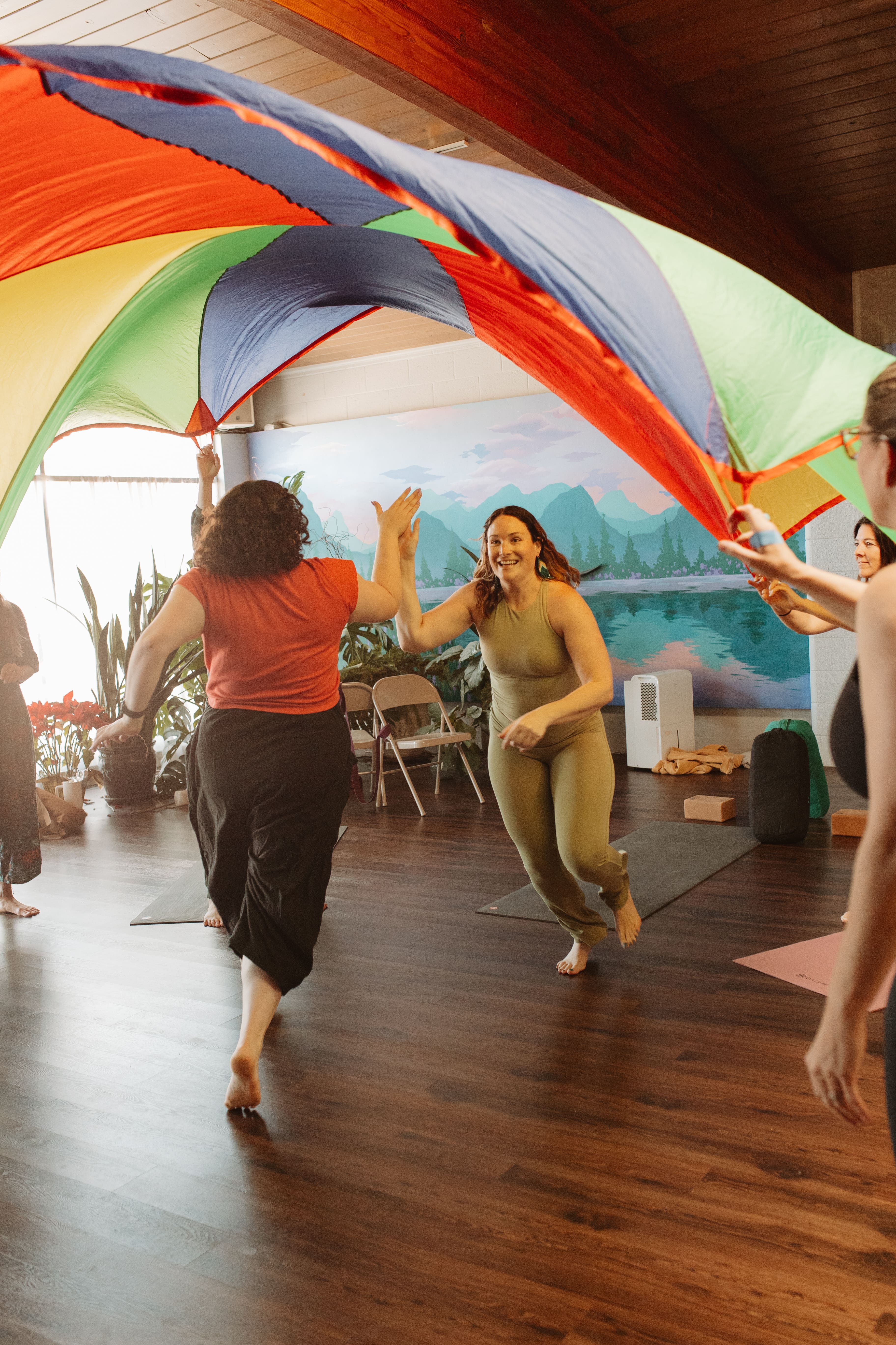 Parachute games in a kids yoga class