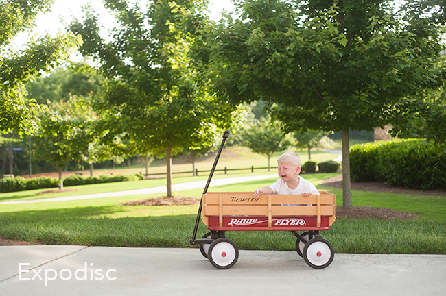photo of a child sitting in a wagon crying.