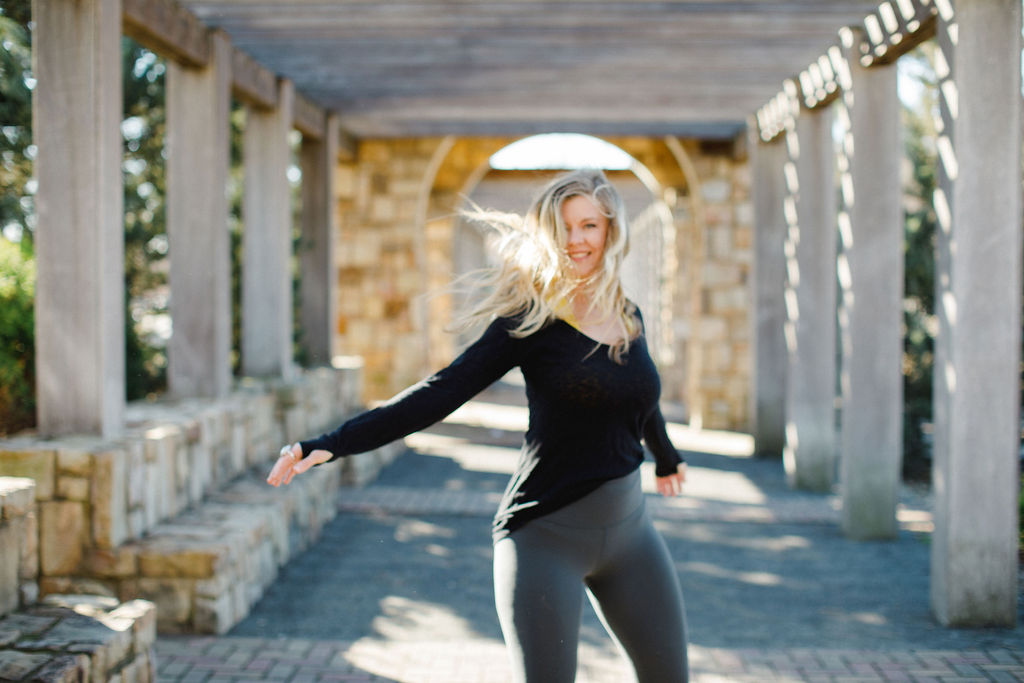 Woman stretching in nature, embracing real wellness and presence