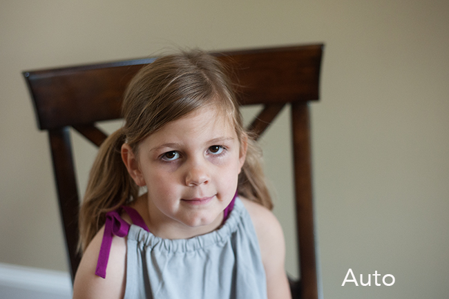 Photo of child sitting in a brown chair showing auto white balance.