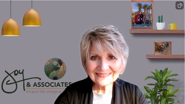 joy huntsman, master coach and founder of joy and associates, in a professional headshot with a warm smile and textured scarf.