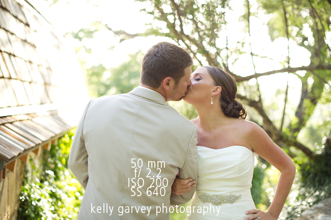bride and groom kissing on wedding day taken with 50mm lens