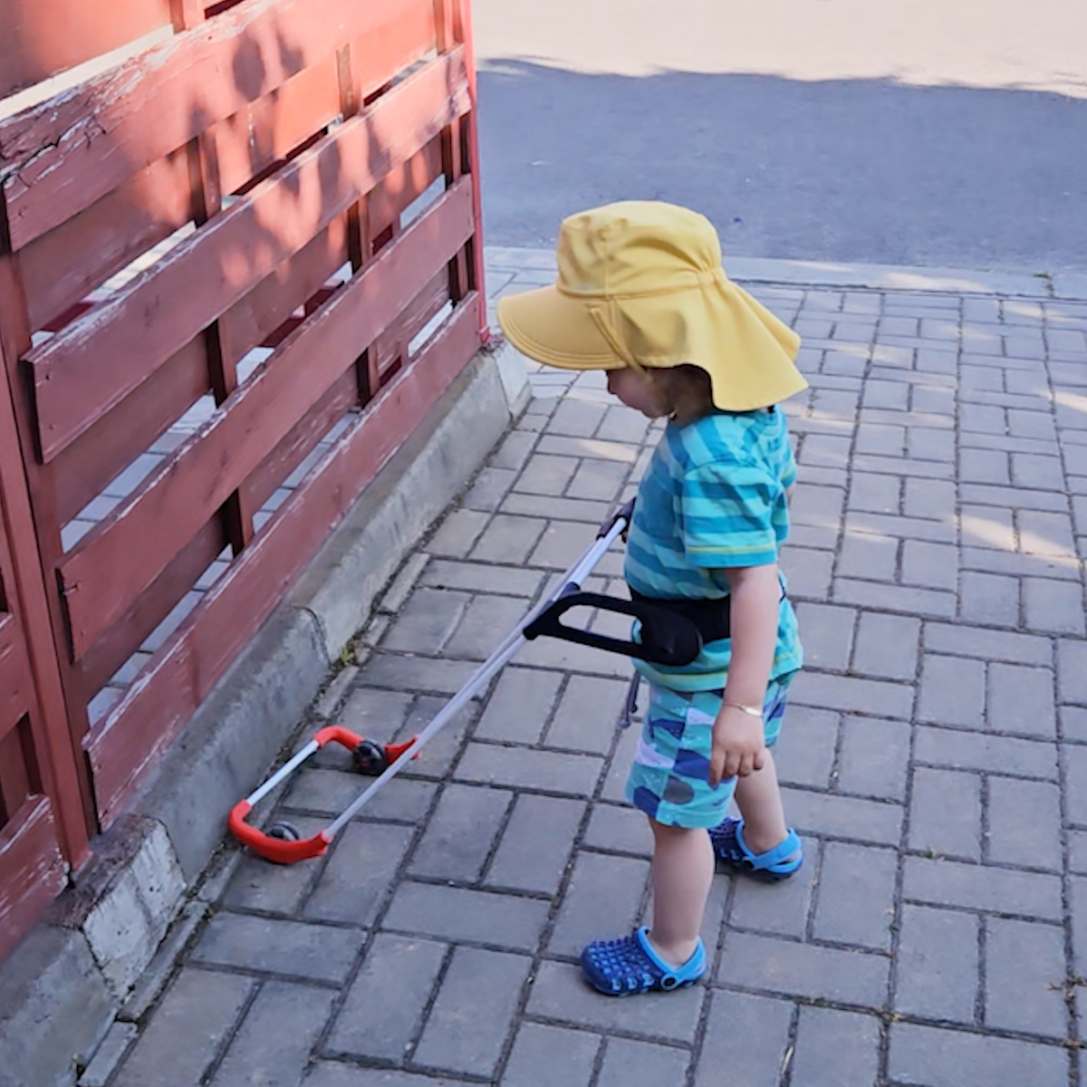 1-year-old boy seen from behind wearing a properly fitting belt cane