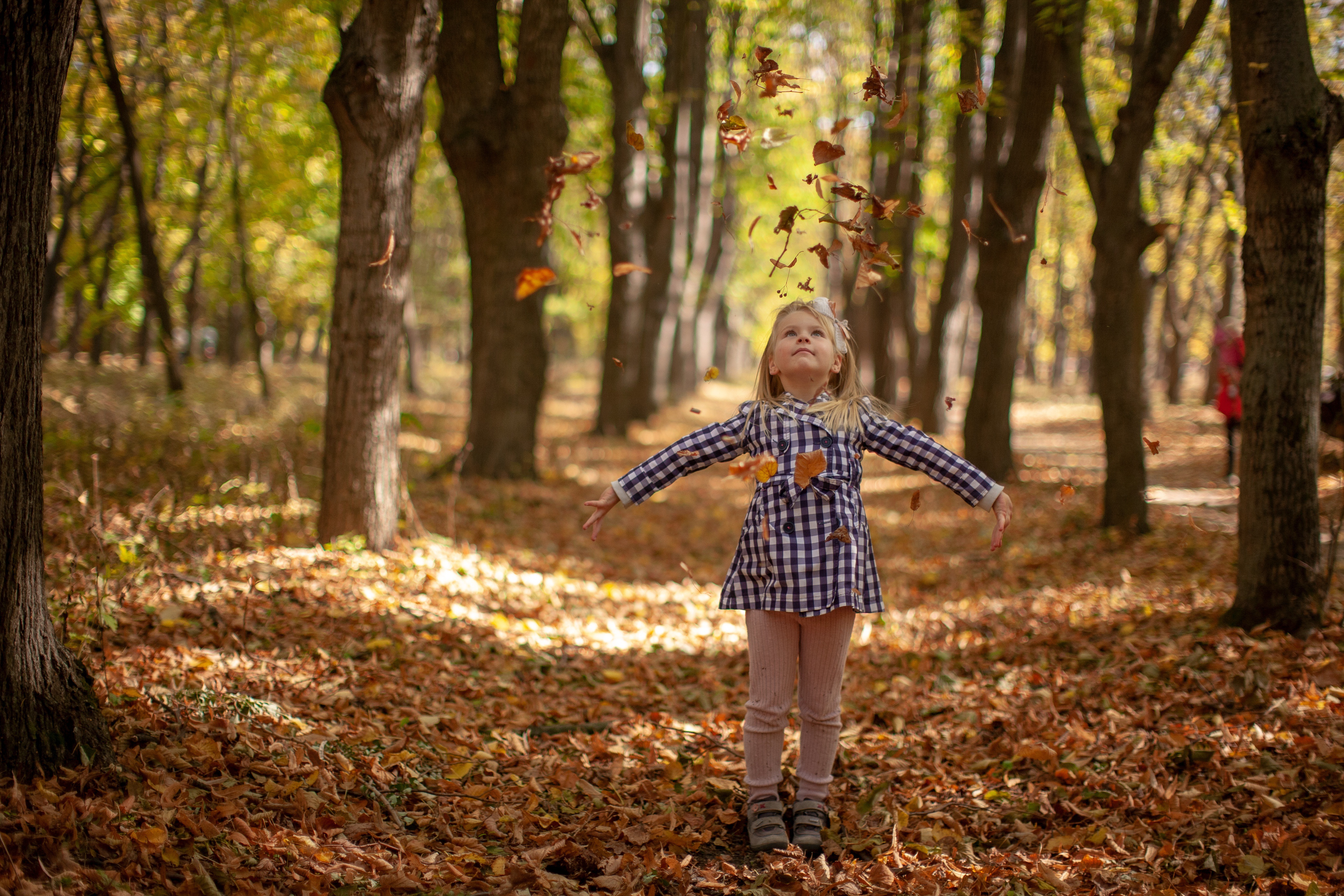 Child throwing leaves