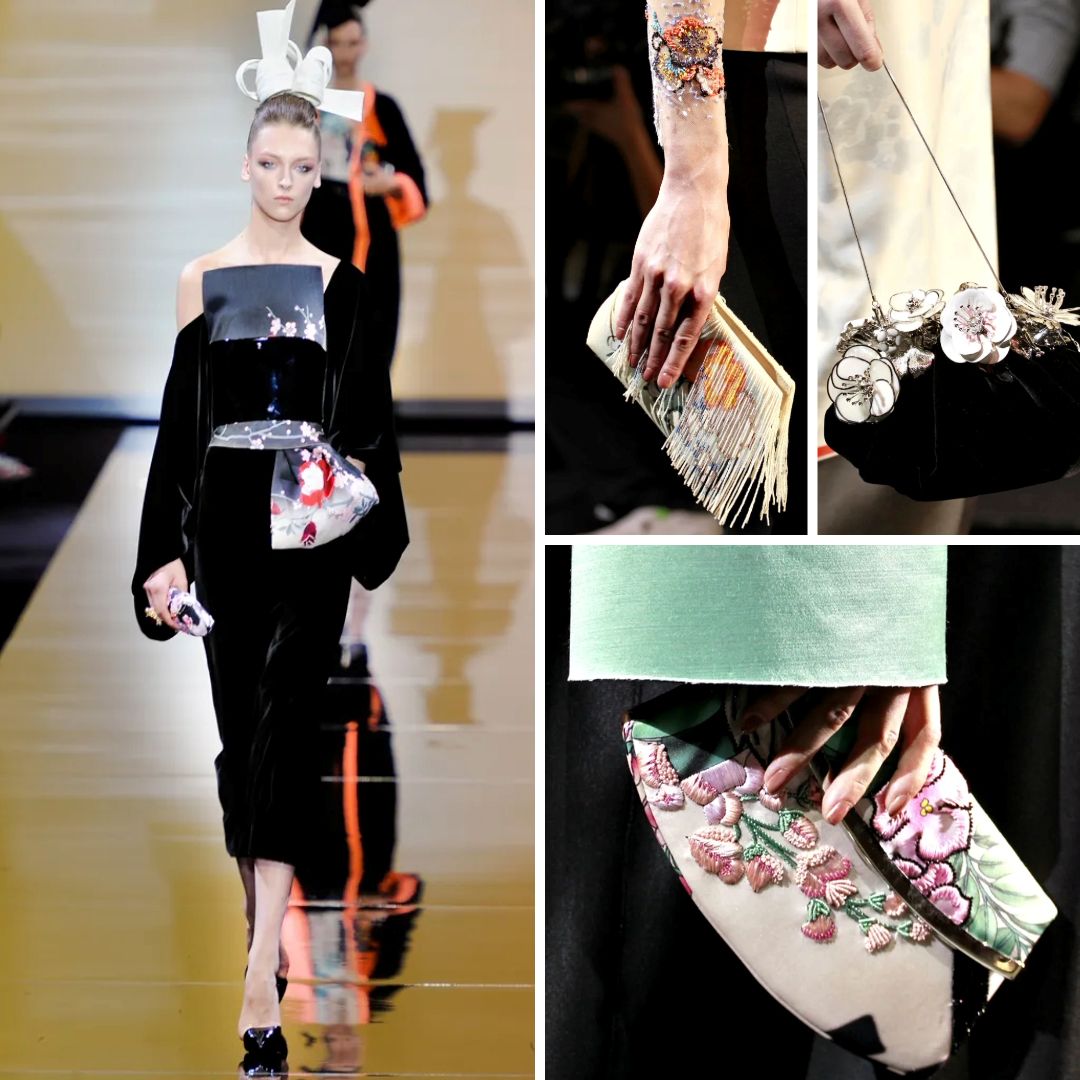  A model walks the runway in a structured black velvet dress with a floral-printed obi belt, inspired by traditional Japanese kimonos. Accessories include a sculptural headpiece and embroidered clutches with floral and fringe details