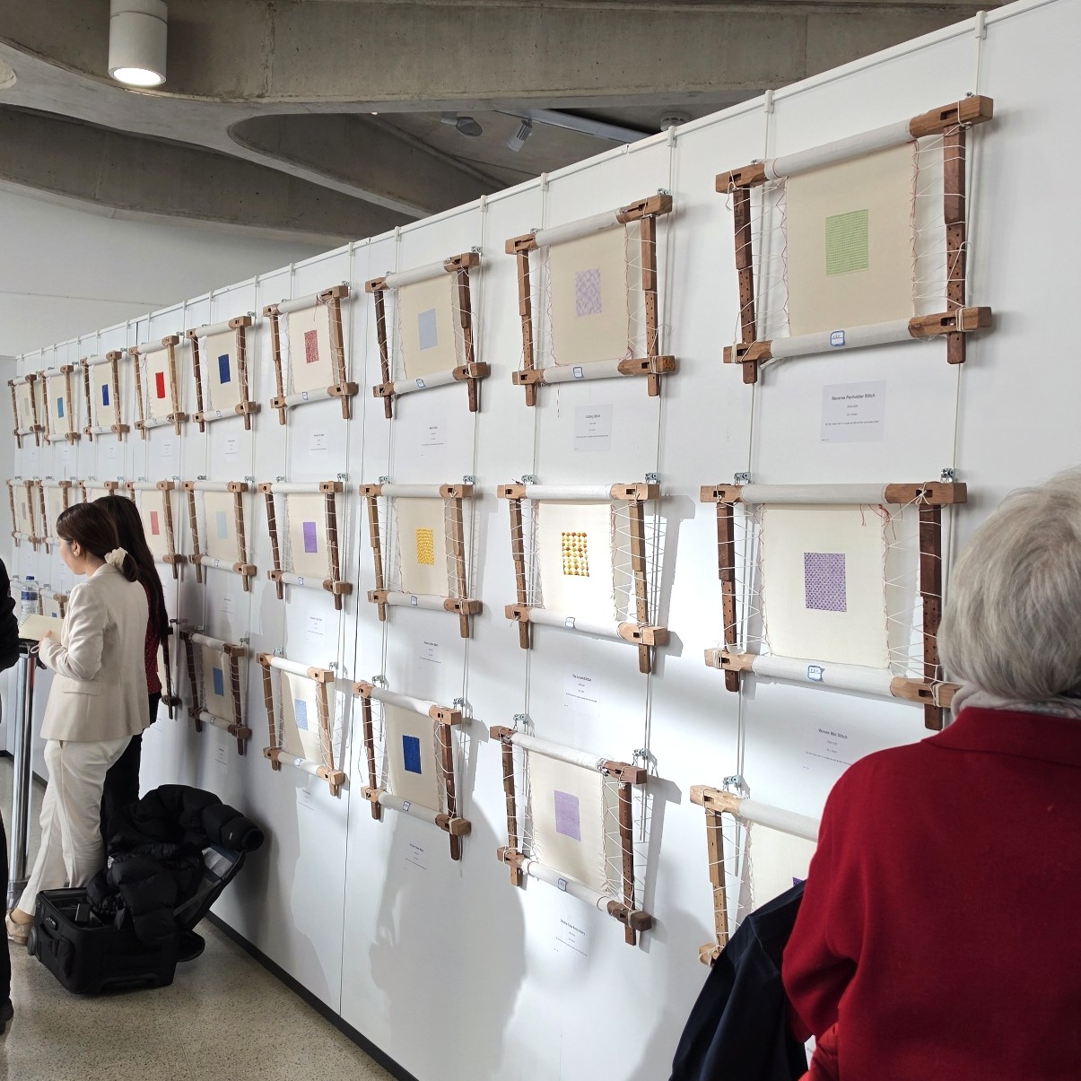 Display of Suzhou embroidery stitch techniques mounted on embroidery frames at the Royal Geographical Society exhibition in London