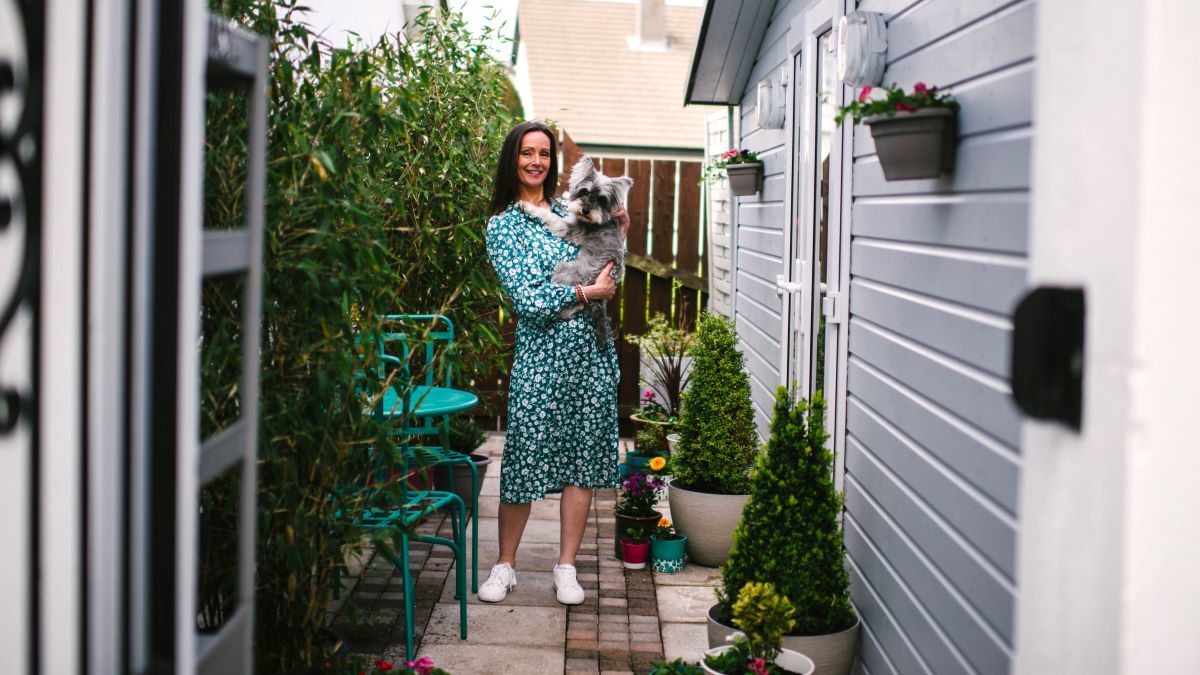 Lynsay Green and her dog phoebe outside studio in garden