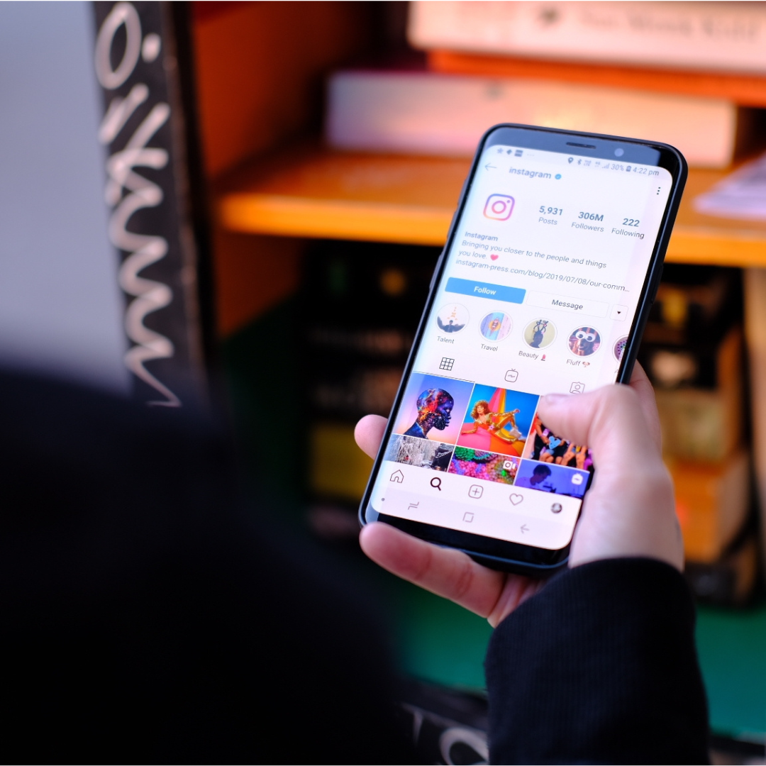 person holding a phone with instagram open
