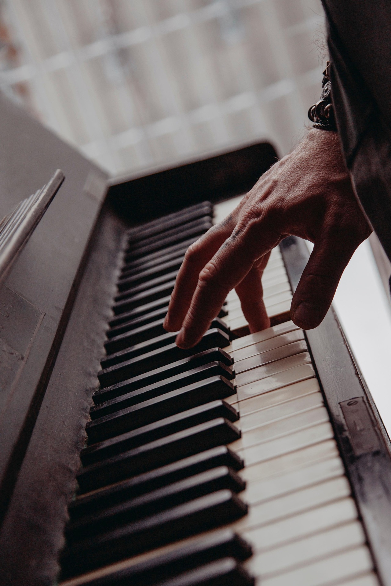 old acoustic piano being played by male hand