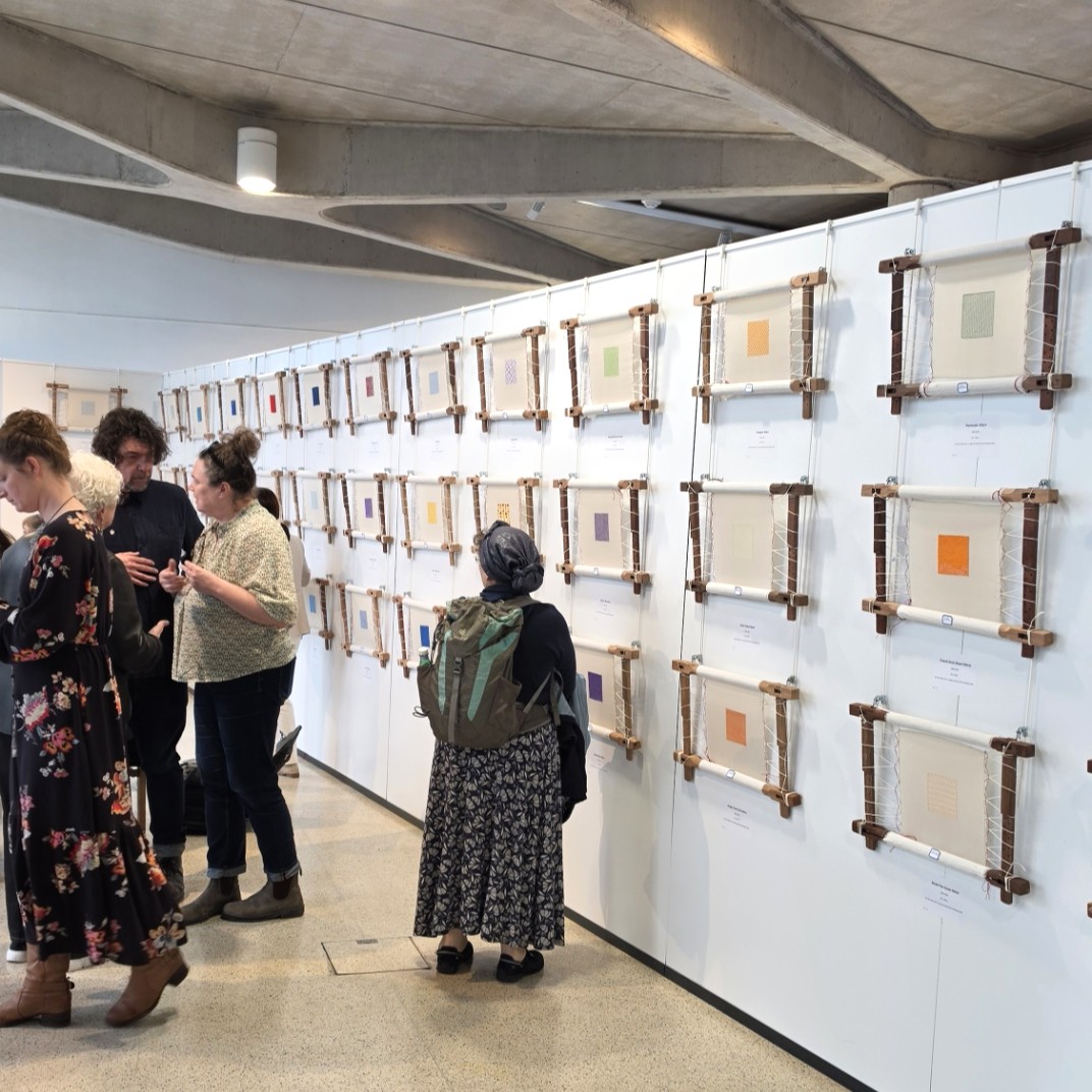 Visitors viewing Suzhou embroidery stitch technique samples at the Royal Geographical Society exhibition in London