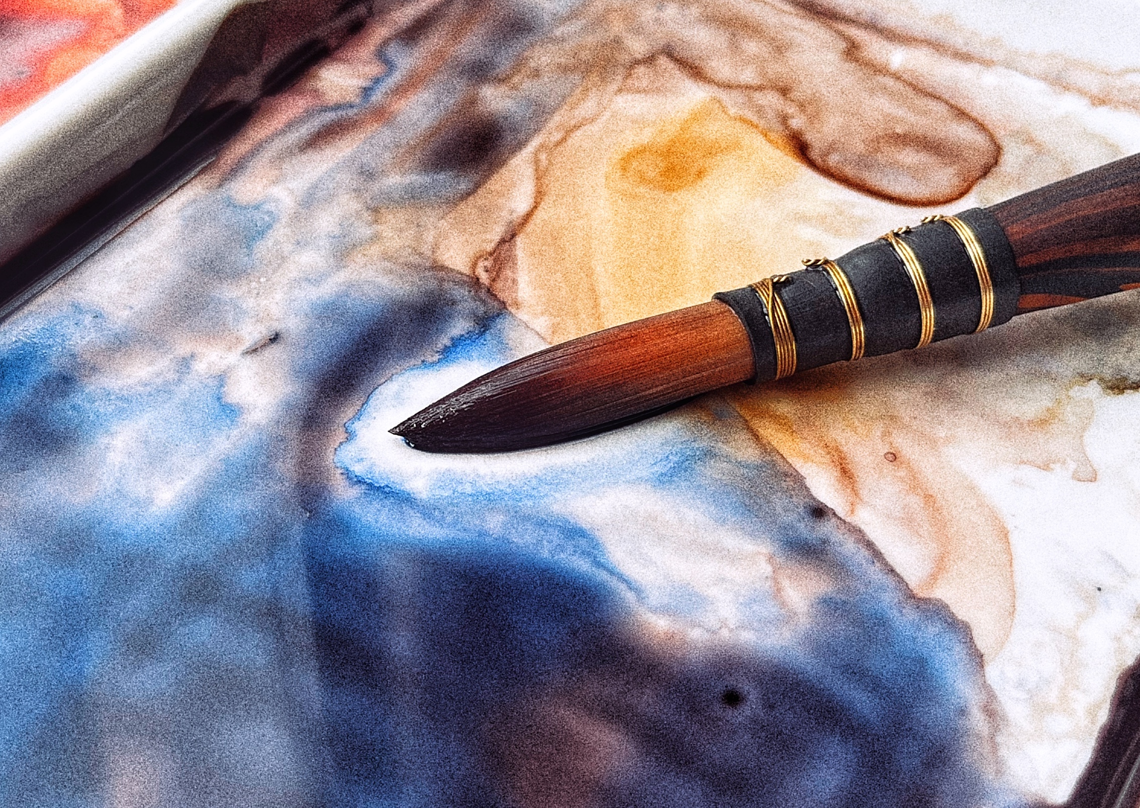 Close-up of a Brush Resting on a Ceramic Palette, Blue Mixed Paint