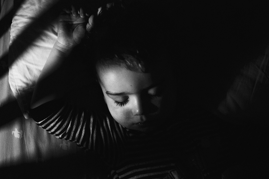child sleeping with lights acting as leading lines