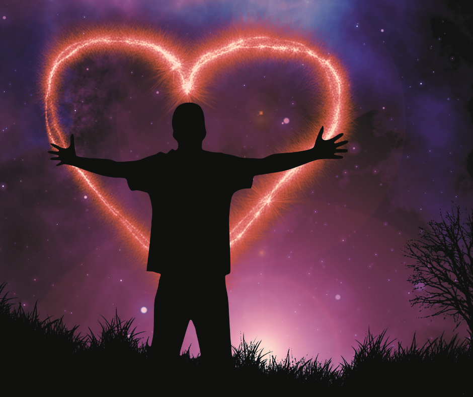  person embracing a giant brightly lit heart