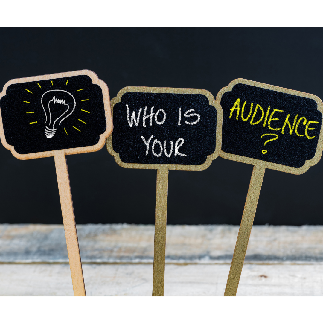 photo with 3 signs, one with a light bulb, one that says "who is your" and the last one "audience"