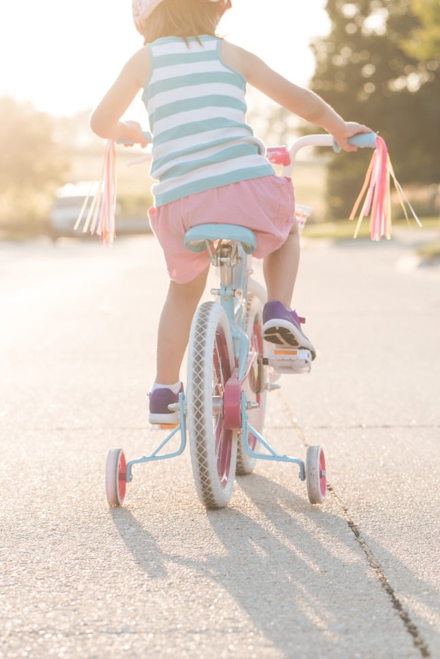 Child riding bike with airy light helps create unique photography style