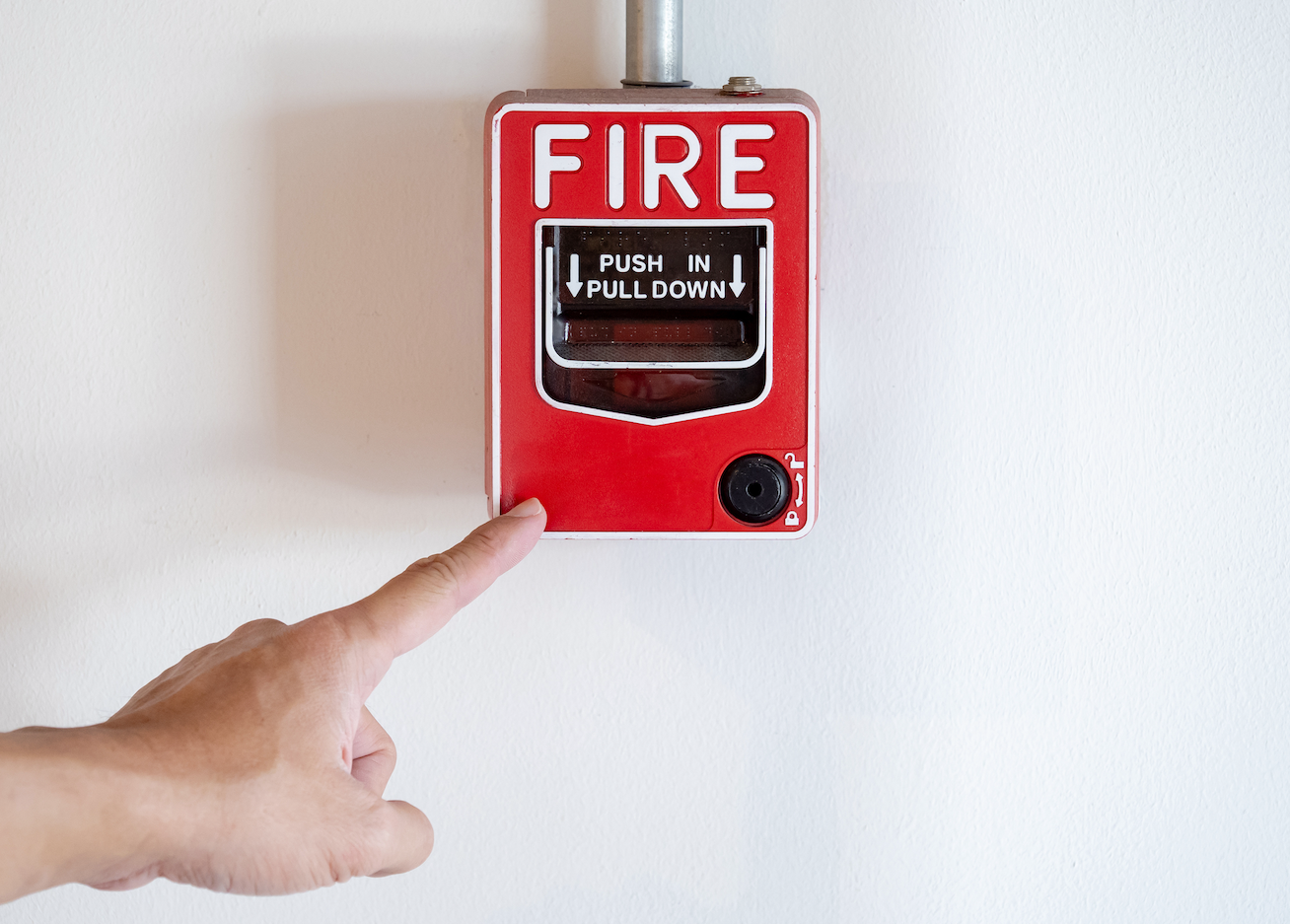 Fire Alarm with hand looking to pull lever.
