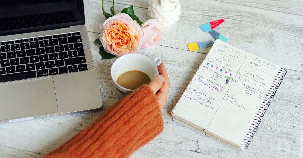 Woman working and holding a coffee cup