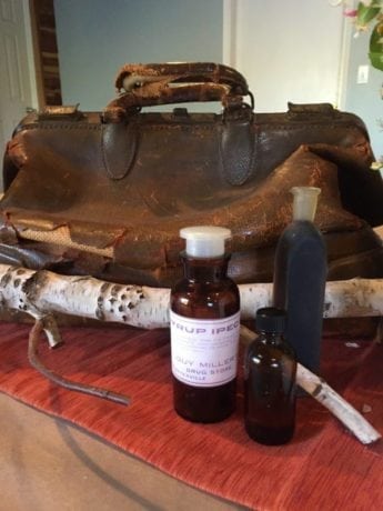 . . . she stood up, grasping with one thin brown hand the handle of a shabby, old-fashioned carpet-bag; the other she held out to him. —Ch. 2