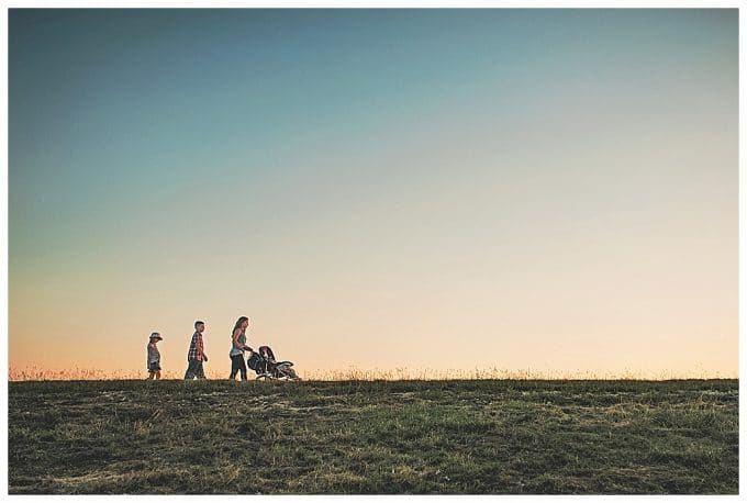 Photo of family at sunset walking across the horizon.