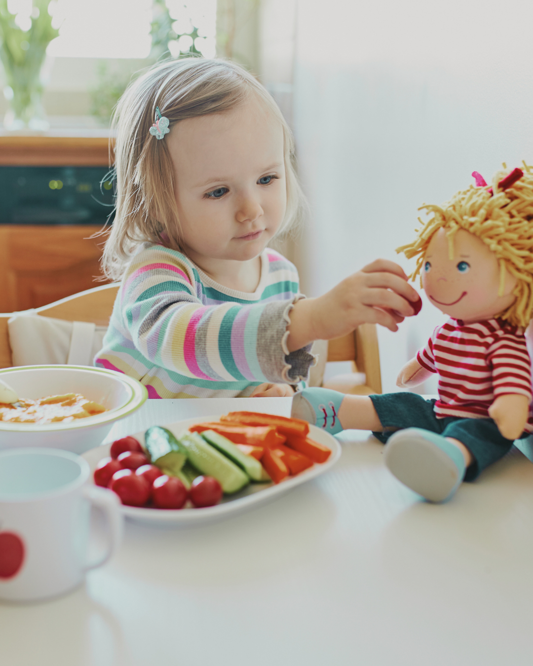 Toddler eating crunchy vegetables like carrots and cucumber to strengthen jaw muscles and support oral development