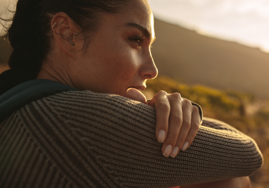 A woman sitting down reflecting